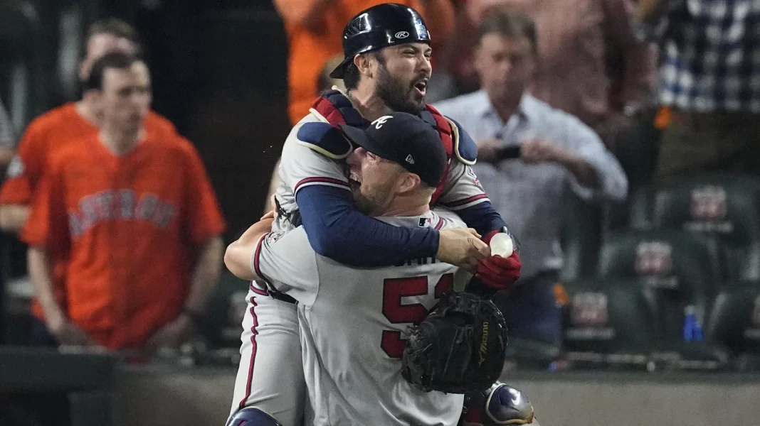 Atlanta Braves relief pitcher Will Smith and catcher Travis d'Arnaud celebrate after winning baseball's World Series in Game 6 against the Houston Astros Tuesday, in Houston. The Braves won 7-0.