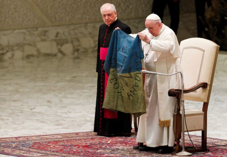 Pope condemns ‘the massacre of Bucha’ and kisses Ukrainian flag