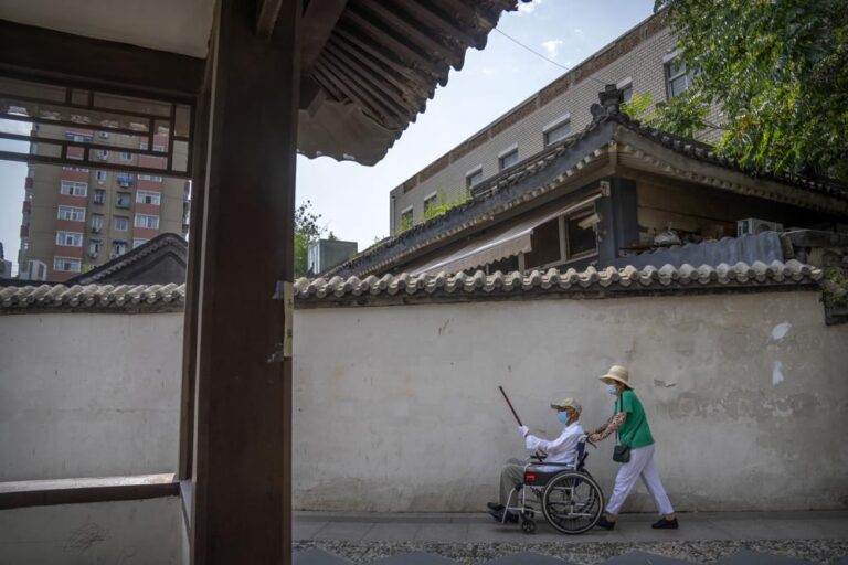 Beijing appears to back off vaccine mandate after pushback